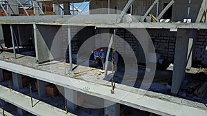 Aerial Shot Of Builders Team On Construction Site Discussing Plan Of Project With Architect And Contractor Using