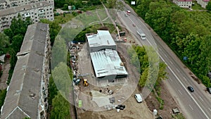 Aerial Shot of the Building in the Process of Construction warehouse, retail space . Labor working in big construction