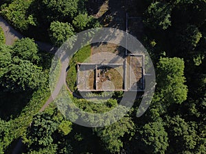 Aerial shot of building's wall ruins surrounded by trees