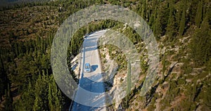 Aerial shot of a car following a winding road of Kefalonia island in Greece