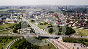 Aerial shot of a car moving on highway overpass, ringway, roundabout