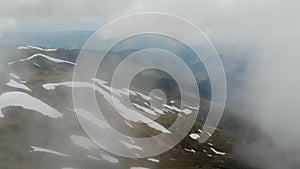 Aerial shot of the Carpathian range covered with shining snow and fog