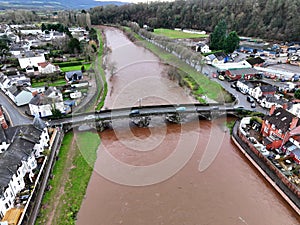 Aerial shot of the cars driving on the Usk bridge over the river