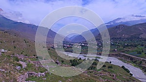 Aerial shot from caucasus mountain in Ossetia. View to the mountains, mountain river, lost village and fantastic sky 4K