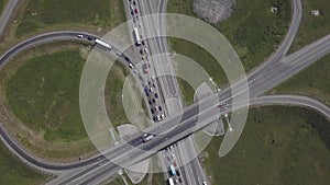 Aerial shot of city road traffic over big crossroad. Cars, buses and trucks driving by avenue. Vertical view.