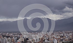 Aerial shot of a cityscape full of buildings and houses on a cloudy weather