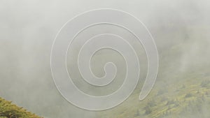 Aerial shot of the Ciuc mountain range in Romania on a foggy day