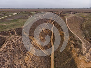 Aerial Shot of clay hills with canyons near the Black sea at Misty Autumn weather. Stanislavs mountains, Kherson region