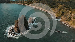 Aerial shot of a cliffy seashore near the ocean in daylight