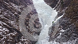 Aerial shot of climbers on a frozen waterfall in the alps.