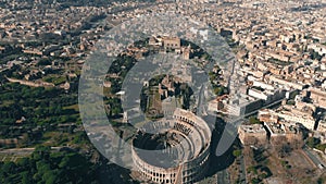 Aerial shot of Colosseum or Coliseum amphitheatre within cityscape of Rome, Italy