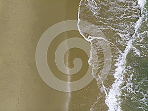 Aerial shot of the couple on the white sand beach in Thailand