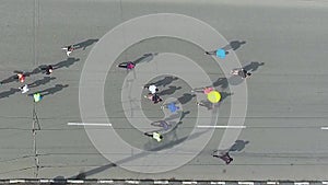 Aerial shot of crowd of people running marathon on city road