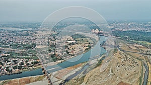 Aerial shot of densely-populated Agra city and Taj-Mahal on the background