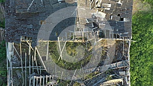 Aerial shot of a destroyed rooftop of a soviet farm building.