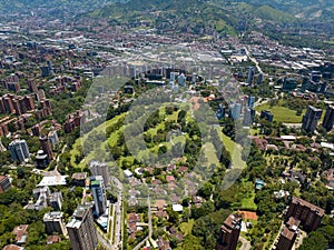 Aerial shot of a downtown El Poblado in Medellin, Colombia with green-covered hills on background photo
