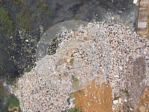 Aerial shot of drone Of plastic waste That were left piled up near the water source Causing environmental pollution problems