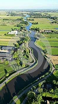 Aerial shot of the Eem River meandering through the picturesque countryside of Eemnes, Netherlands