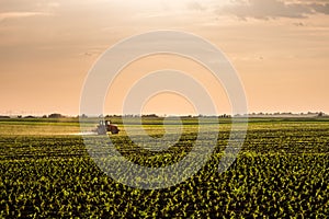 Aerial shot of a farmer plowing stubble field