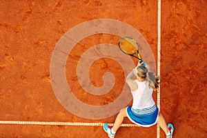 Aerial shot of a female tennis player on a court during match. Young woman playing tennis.High angle view.