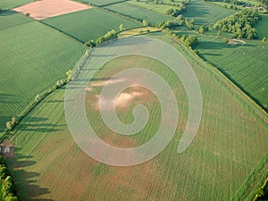 Aerial shot of fields with barren patches