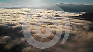 Aerial shot: Flying above Amazing Fluffy Clouds at Morning Time.