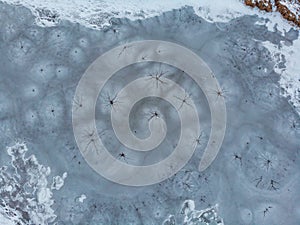 Aerial shot of the frozen lake special surface formations on a cold winter day