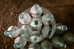 Aerial shot of glass bottles with a blurred brown floor in the background