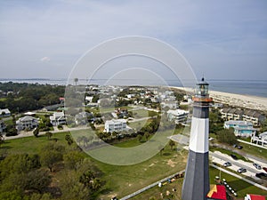 aerial shot of the a gorgeous spring landscape at Tybee Island Beach with the lighthouse, blue ocean water, a brown sandy beach