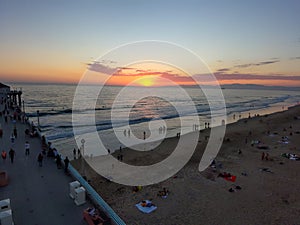 An aerial shot of a gorgeous summer landscape at the Manhattan Beach Pier with a stunning sunset in the sky