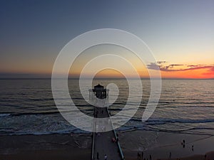 An aerial shot of a gorgeous summer landscape at the Manhattan Beach Pier with a stunning sunset in the sky