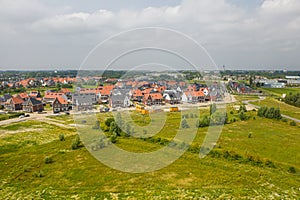Aerial shot of green fields and small town of Middelburg in the Netherlands on the background