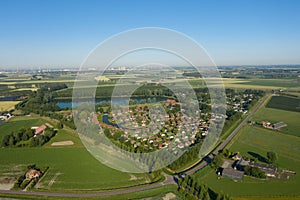 Aerial shot of green fields and small town of Middelburg in the Netherlands on the background