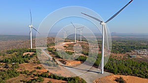 Aerial shot of a group of wind turbines in a semidesert environment. Green energy concept
