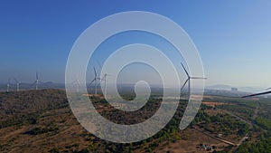 Aerial shot of a group of wind turbines in a semidesert environment. Green energy concept