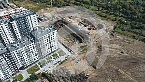 Aerial shot Heavy machinery digs a pit for the future home. An excavator digs a deep pit for the construction of a high