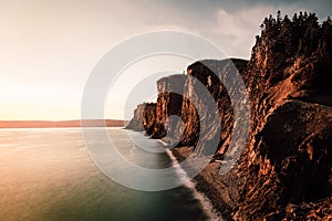 Aerial shot of high cliffs in Advocate Harbor in Nova Scotia at sunrise, Canada