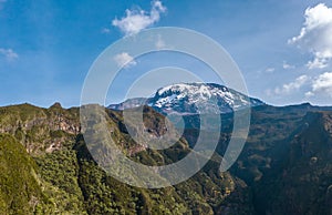 Aerial shot of a highest African continent summit - Kilimanjaro Uhuru Peak 5895m volcano covered with snows. Drone point of view