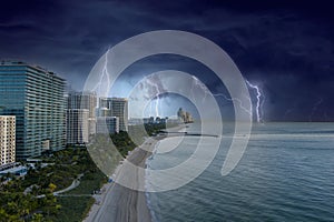 aerial shot of hotels, luxury condos and skyscrapers along the coastline at sunrise at Bal Harbour Beach, blue ocean water