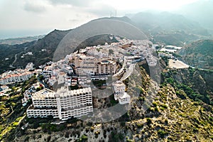 Aerial shot houses rooftops and mountains of Mojacar village. Spain