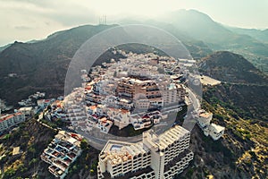 Aerial shot houses rooftops and mountains of Mojacar village. Spain