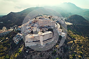 Aerial shot houses rooftops and mountains of Mojacar village. Spain