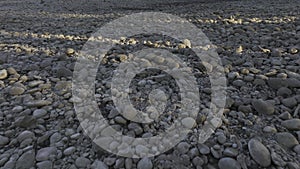 An Aerial Shot Hovering above Stones and Pebbles of a Dried River