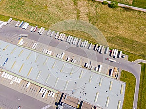 Aerial Shot of Industrial Loading Area where Many Trucks Are Unloading Merchandis