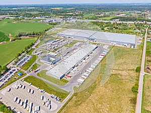 Aerial Shot of Industrial Loading Area where Many Trucks Are Unloading Merchandis