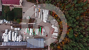 Aerial Shot of Industrial Storage Building Area where Many Trucks Are Loading Merchandise