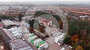 Aerial Shot of Industrial Storage Building Area where Many Trucks Are Loading Merchandise