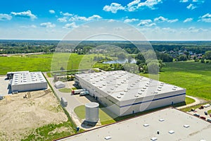 Aerial Shot of Industrial Warehouse Area where Many Trucks Are Loading Merchandise