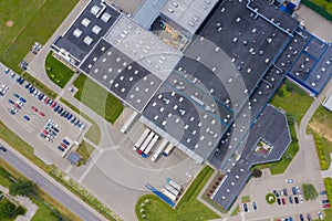 Aerial Shot of Industrial Warehouse Area where Many Trucks Are Loading Merchandise