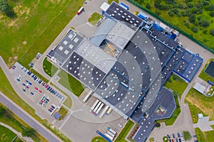 Aerial Shot of Industrial Warehouse Area where Many Trucks Are Loading Merchandise